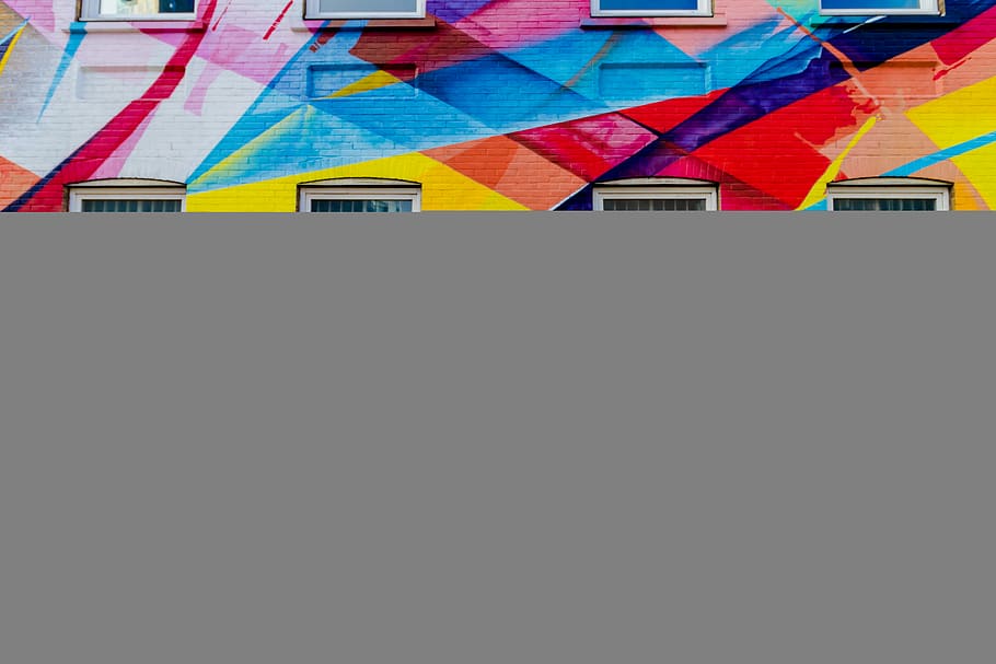 two persons walking on pedway, multicolored concrete structure HD wallpaper