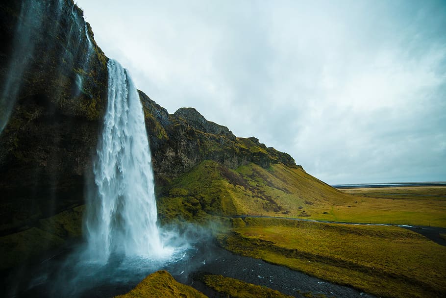 low angle photography of waterfall under cloudy sky, Skogafoss Falls, Iceland HD wallpaper