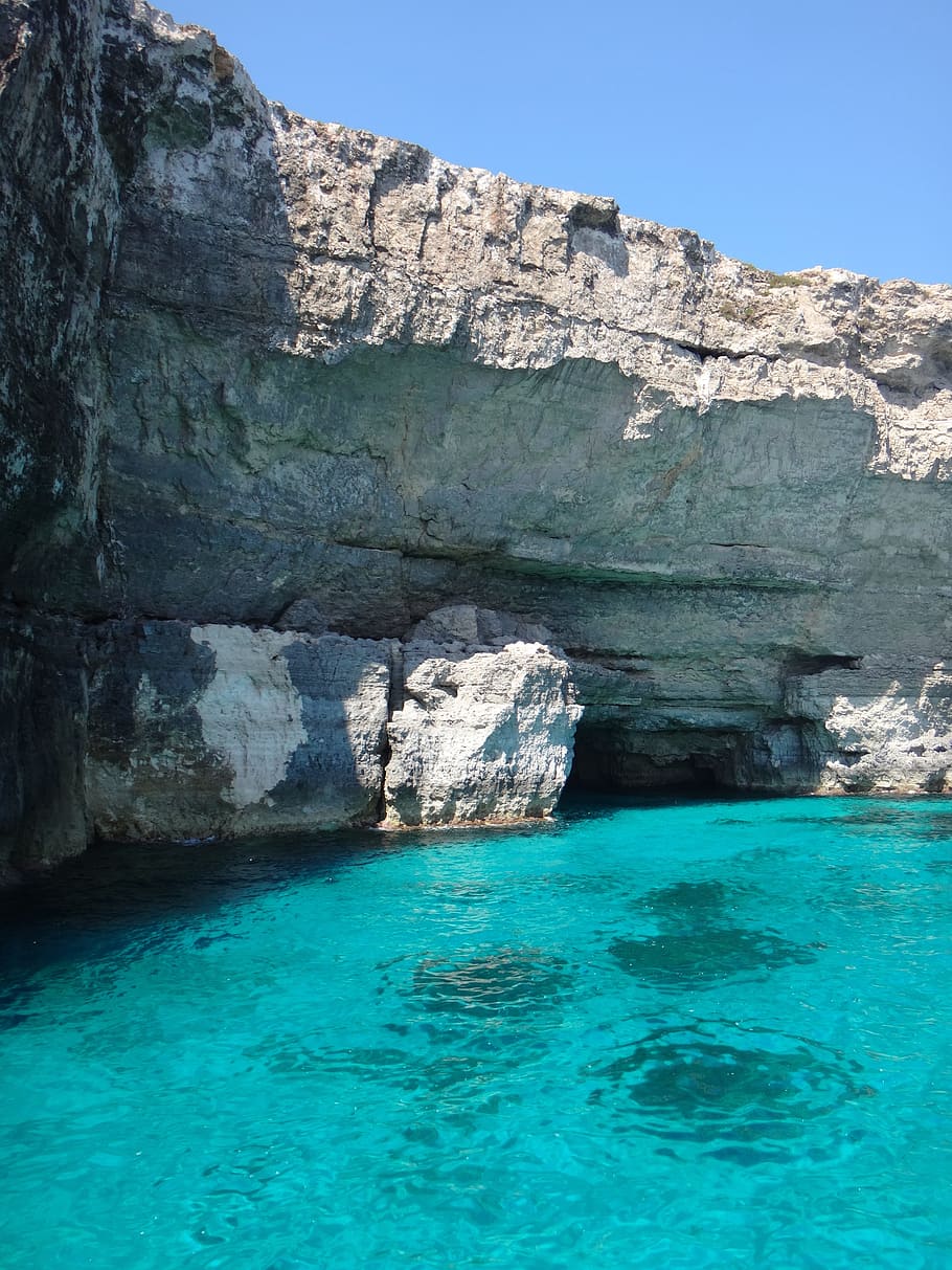 gray rock formation beside body of water under blue sky, malta HD wallpaper