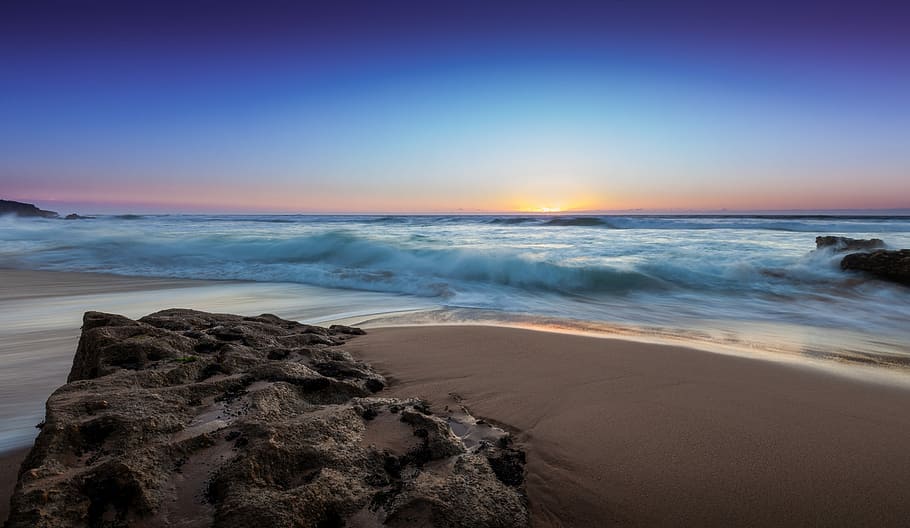 seashore under blue sky, rock formation on seashore during daytime HD wallpaper