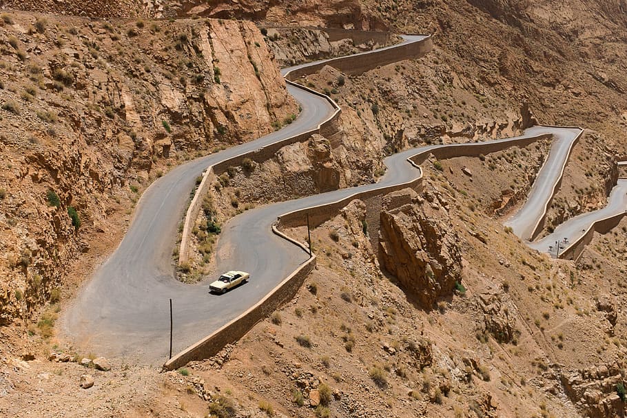 white car traveling on a narrow curve roads at daytime, serpentines HD wallpaper