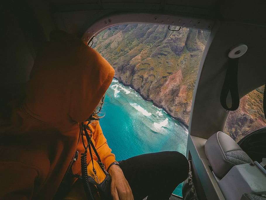 person in aircraft and looking down, person wearing orange hoodie, HD wallpaper