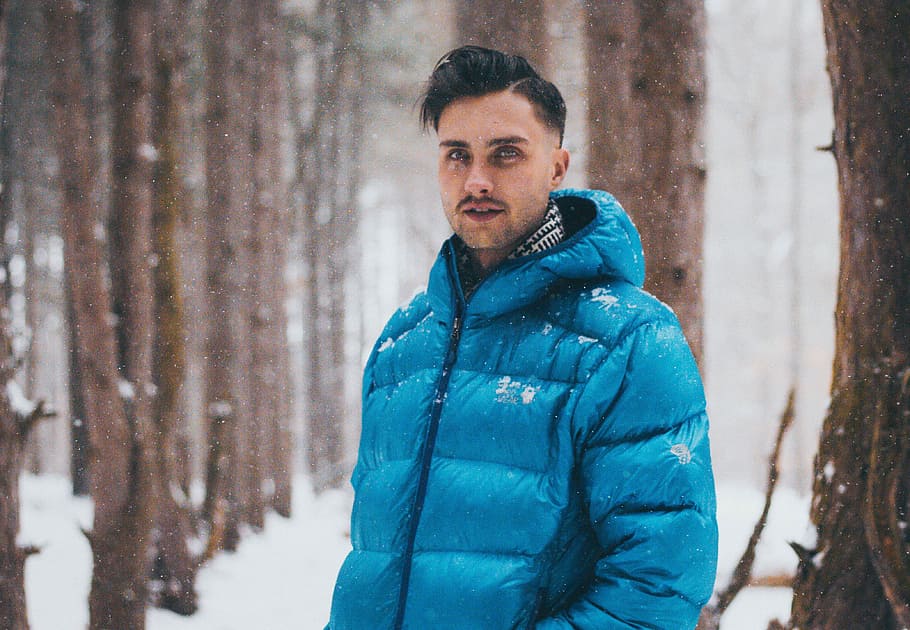 man taking picture on snow sand beside trees, man wearing blue zip-up bobble jacket HD wallpaper
