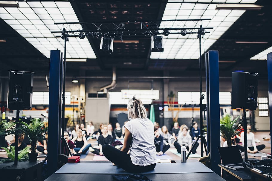 woman sitting in the yoga mat, shallow focus photography of woman wearing white t-shirt HD wallpaper