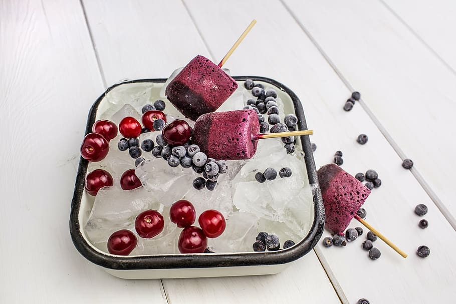 ice cubes with Popsicles and cherries in white bowl, food, fruit