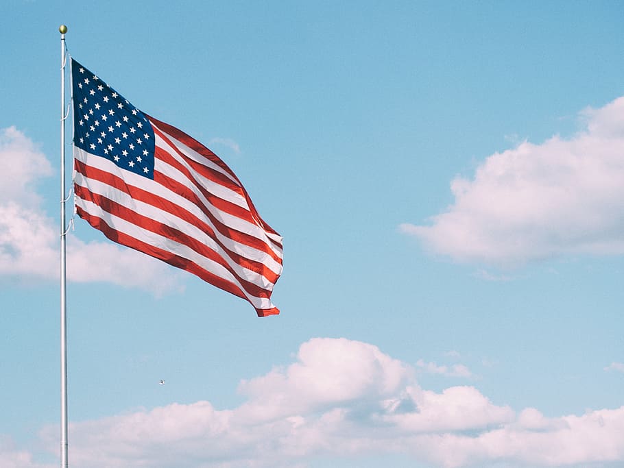 U.S. flag hoisted on gray metal pole under blue cloudy sky at daytime HD wallpaper