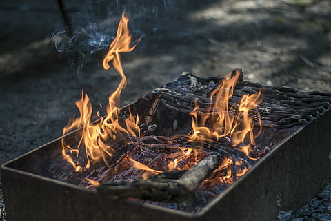 rectangular black fire pit with fire at daytime, firewood burned outside house during daytime HD wallpaper