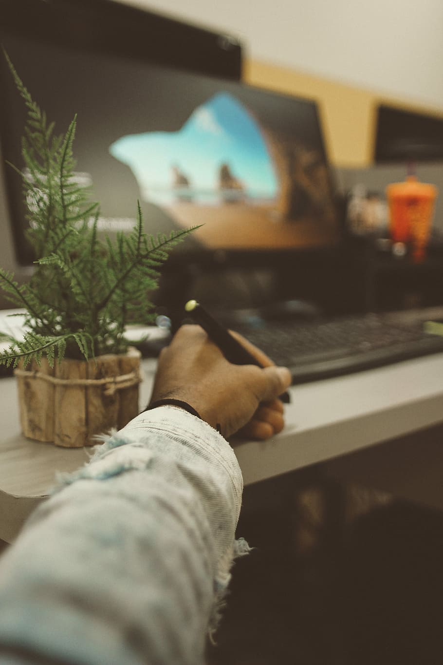 selective photography of person holding pen, person writing on desk HD wallpaper