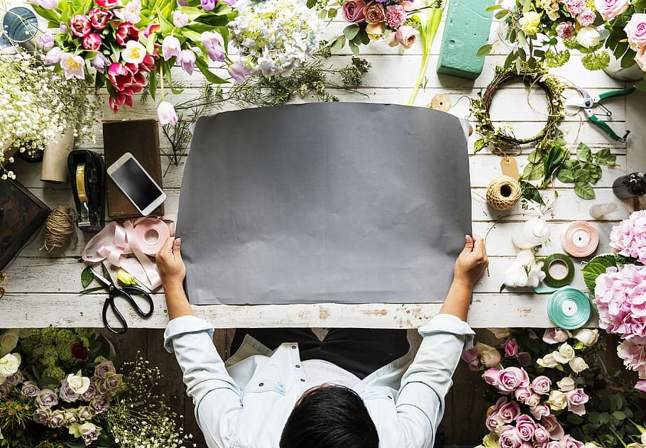 person holding gray mat on table, florist, flowers, scissors HD wallpaper