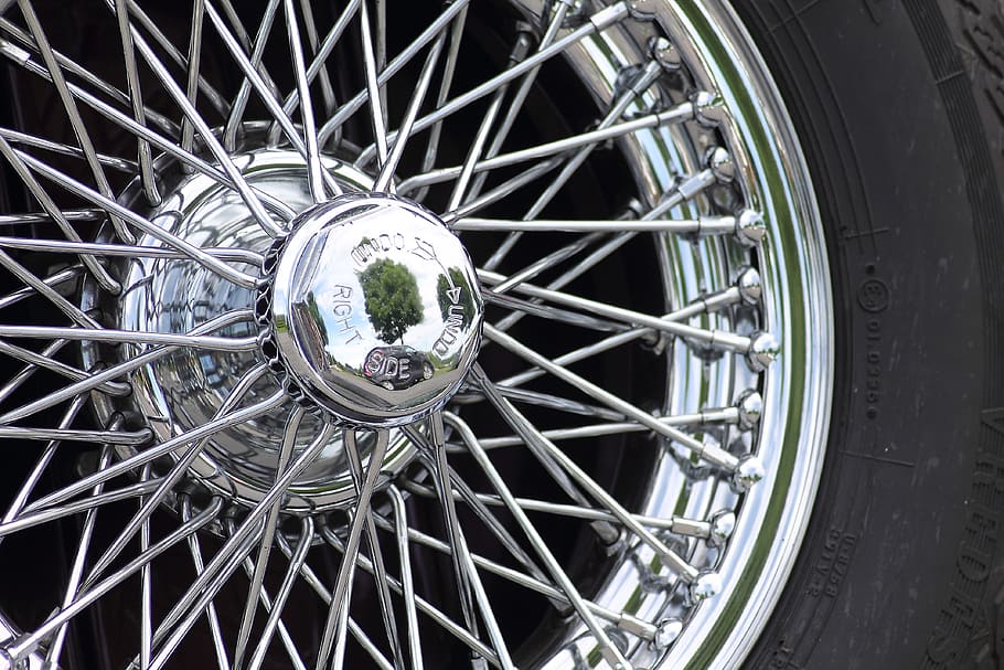 chrome-colored multi-spoke vehicle wheel and tire, cromfelgen