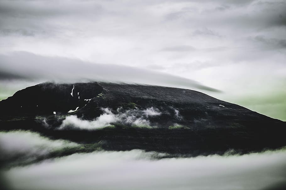 black mountain covered with clouds during daytime, black mountain covered with white smoke under white clouds during daytime HD wallpaper