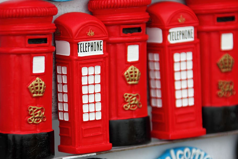 close-up photography of two red telephone booths miniatures HD wallpaper