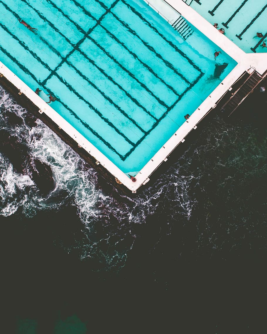 aerial photo of pool near beach, bird's eye photography of people swimming on pool HD wallpaper
