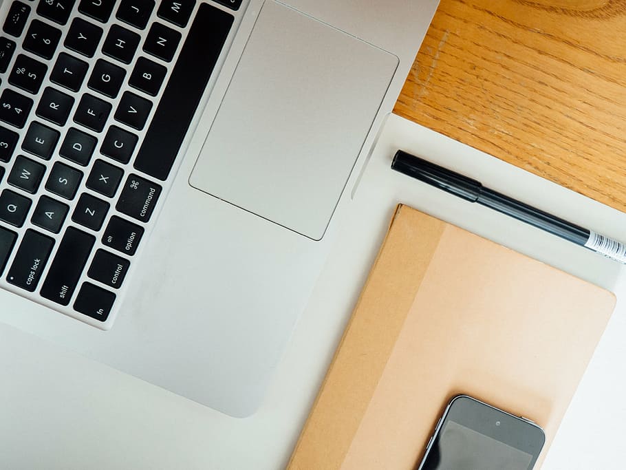 MacBook beside black pen, pro, near, ballpoint, brown, wooden, HD wallpaper