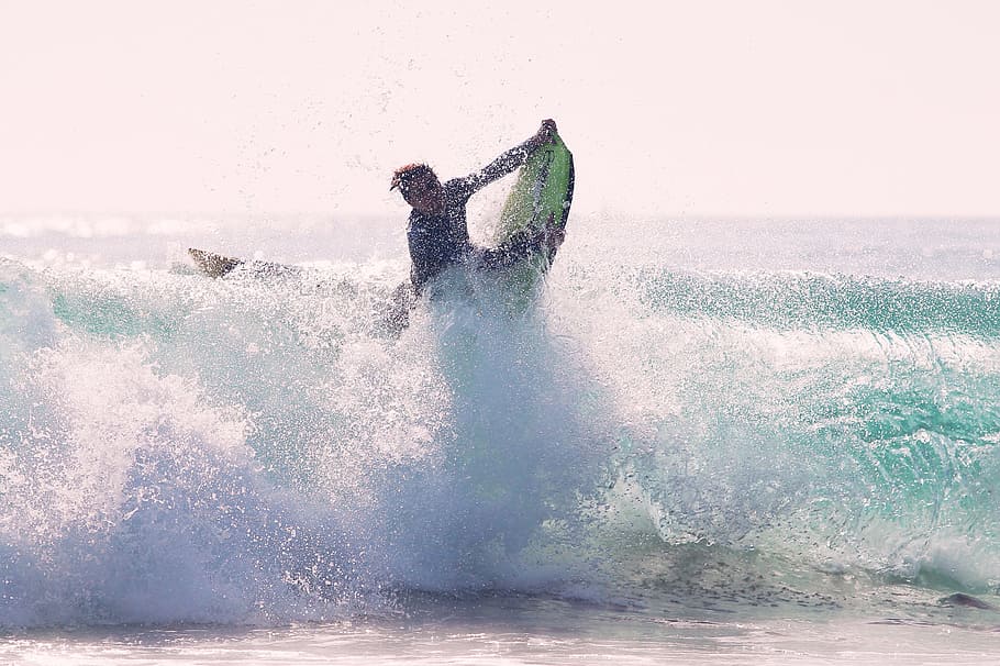 man riding bodyboard, photo of person skim boarding during day time HD wallpaper