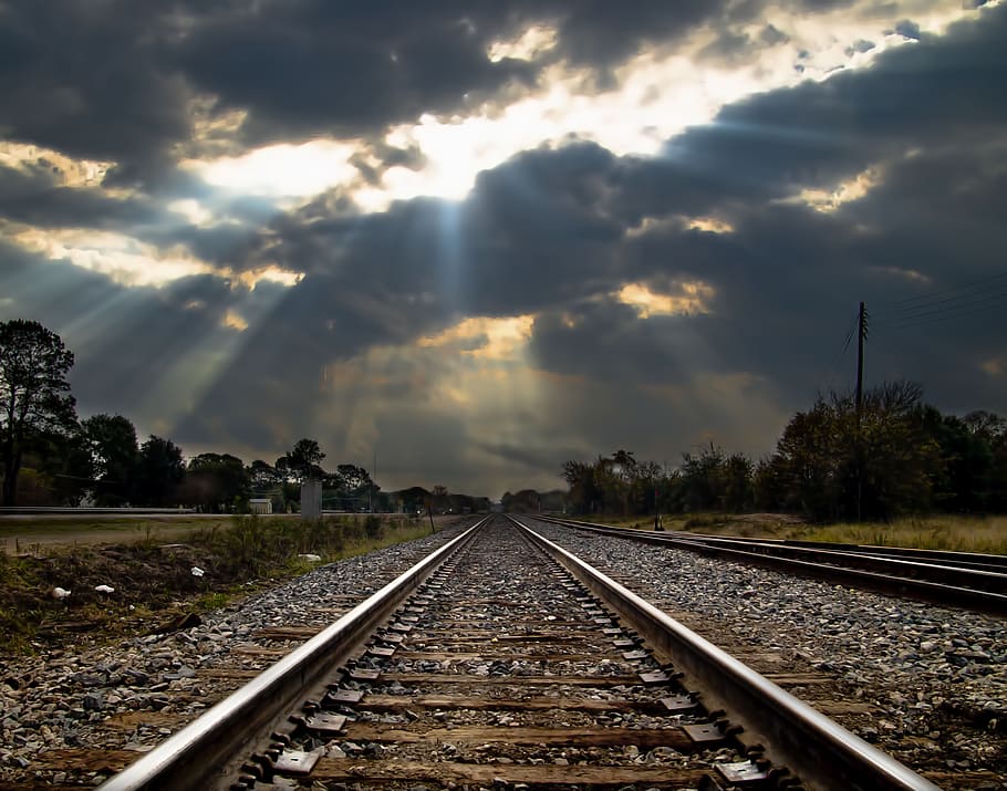 photo of train rail under crepuscular rays background, railroad HD wallpaper