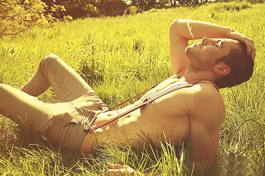 man in gray fitted jean with red suspender lying on grass field during daytime HD wallpaper