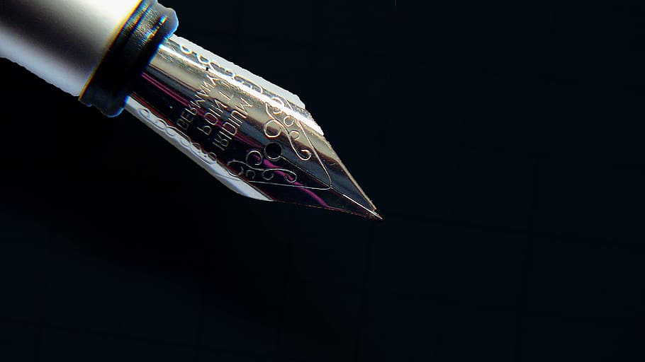 silver fountain pen on black background, filler, writing implement