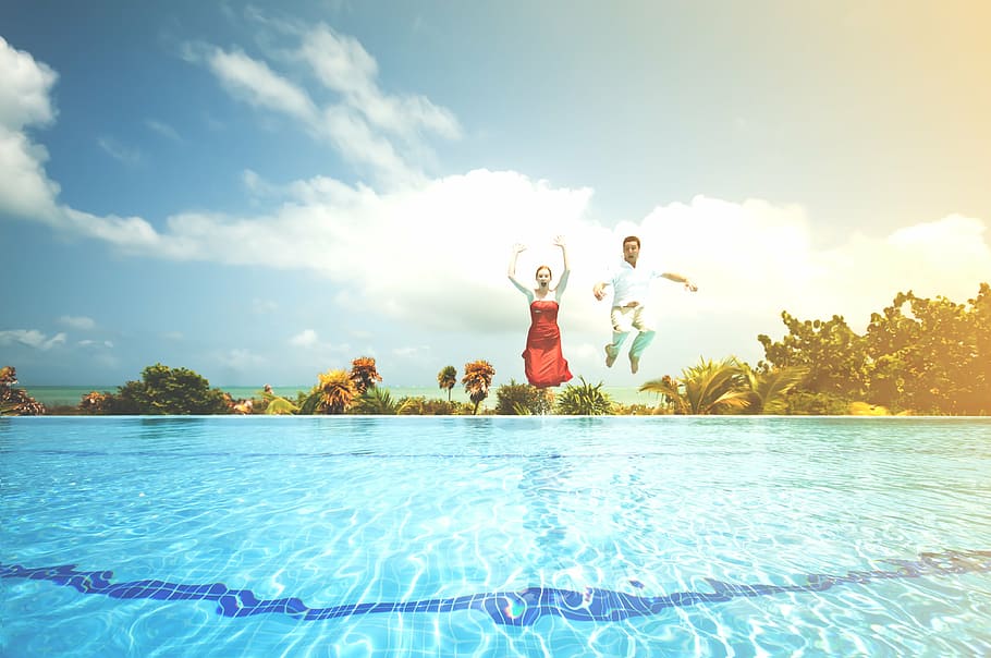 man and woman jumping on pool during daytime, people, dressed up, HD wallpaper