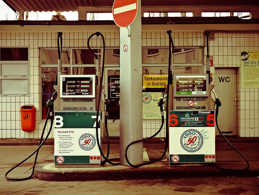 white post in between two assorted-color gasoline pumps dispensers near tiled wall, HD wallpaper