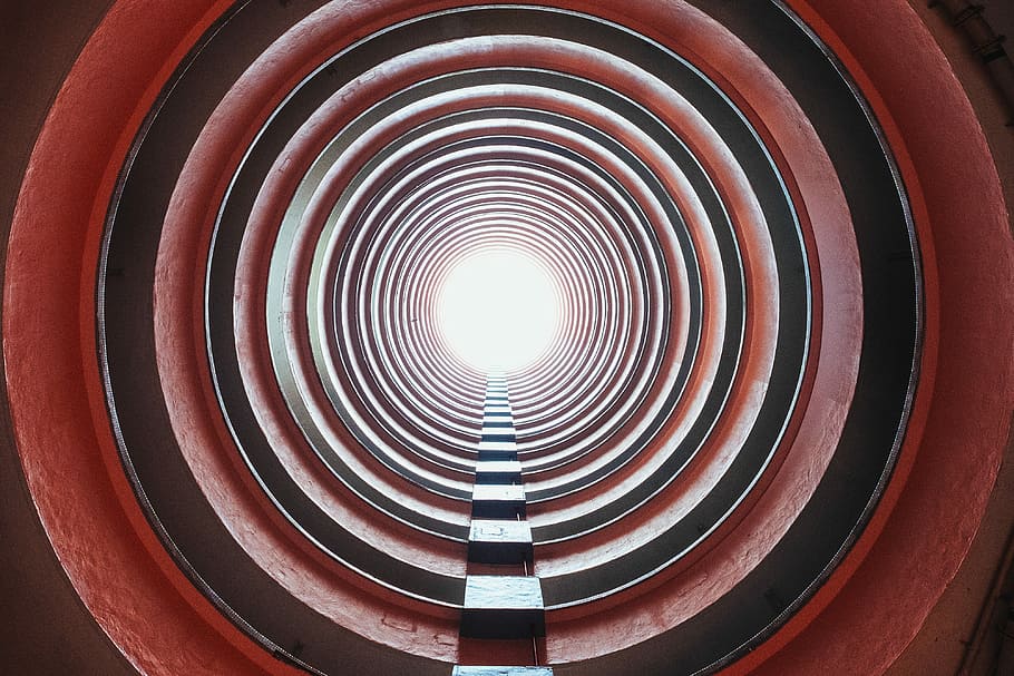low angle photo of red concrete building, tunnel view, city, circle HD wallpaper
