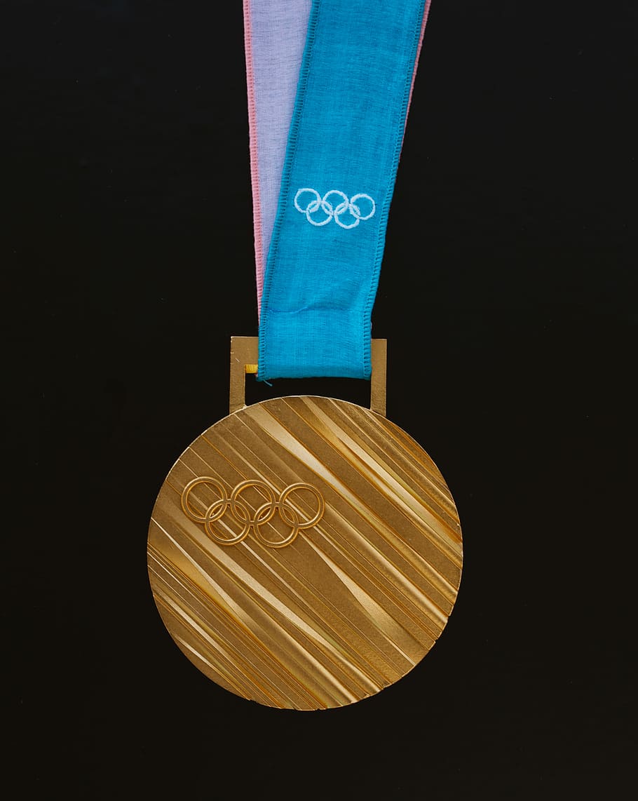 gold-colored Olympics medallion, gold olympic medal, gold medal