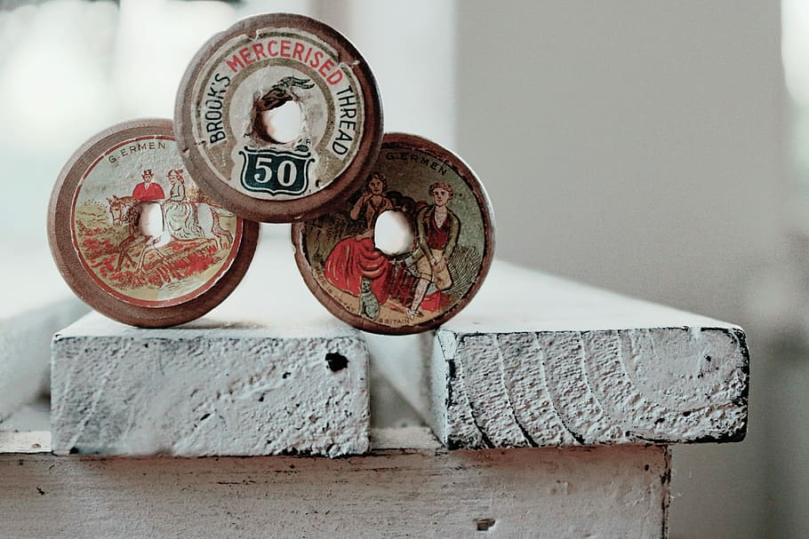 photo of three assorted-color-and-design commemorative coins, three threads HD wallpaper