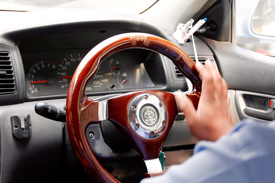 person sitting on driver's seat, steering wheel, handlebars HD wallpaper