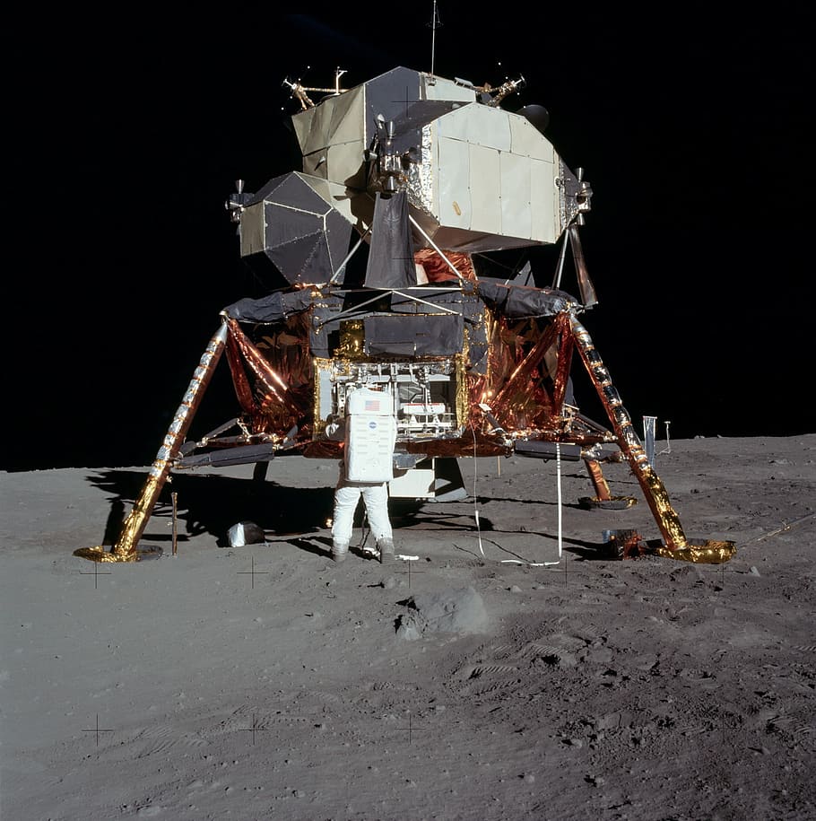 standing astronaut beside gray and brown spacecraft, person, spaceship