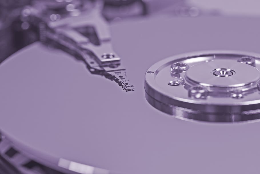 focus photography of silver-colored accessory, hard drive, detail