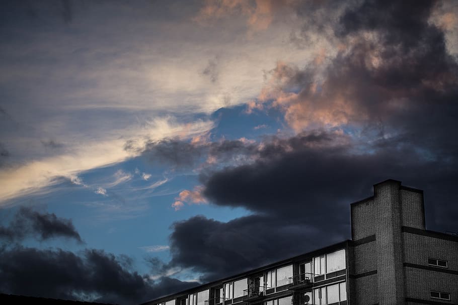 landscape photography of white building under dark cloudy sky, building under black sky HD wallpaper