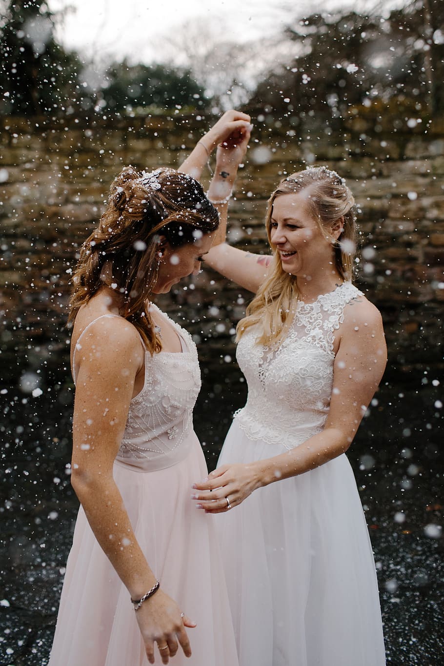 two women wearing sleeveless dress raising their hands, bride HD wallpaper