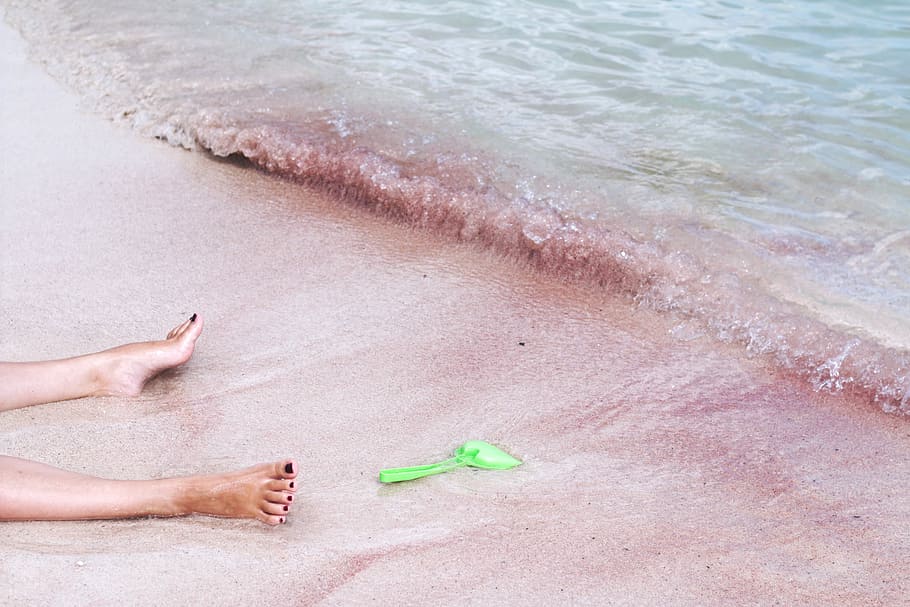 person's foot beside green shovel on seashore, person on beach near at body of water with green plastic shovel HD wallpaper