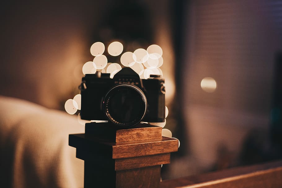 bokeh photography of camera on brown wooden baluster, selective focus photography of black bridge camera HD wallpaper