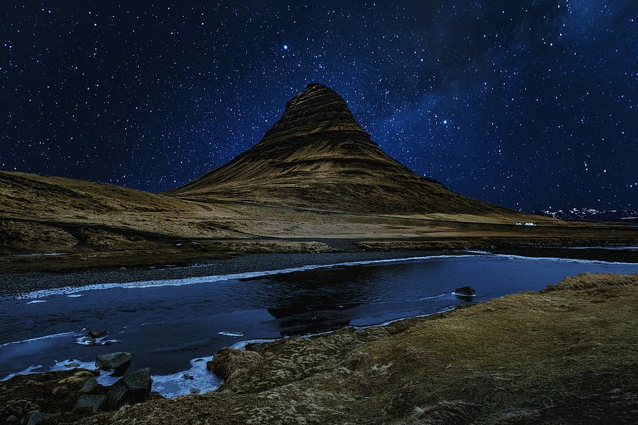 lake near brown mountain, landscape photo of mountain surrounded by body of water during night time HD wallpaper