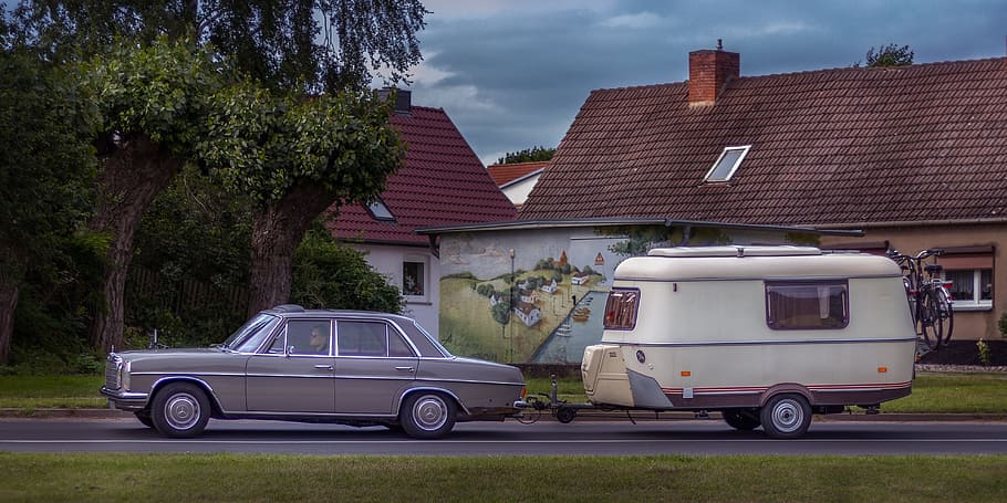classic grey sedan on road with travel trailer, mercedes benz
