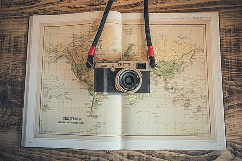 black and gray camera on open map, black and silver camera on top of world map HD wallpaper