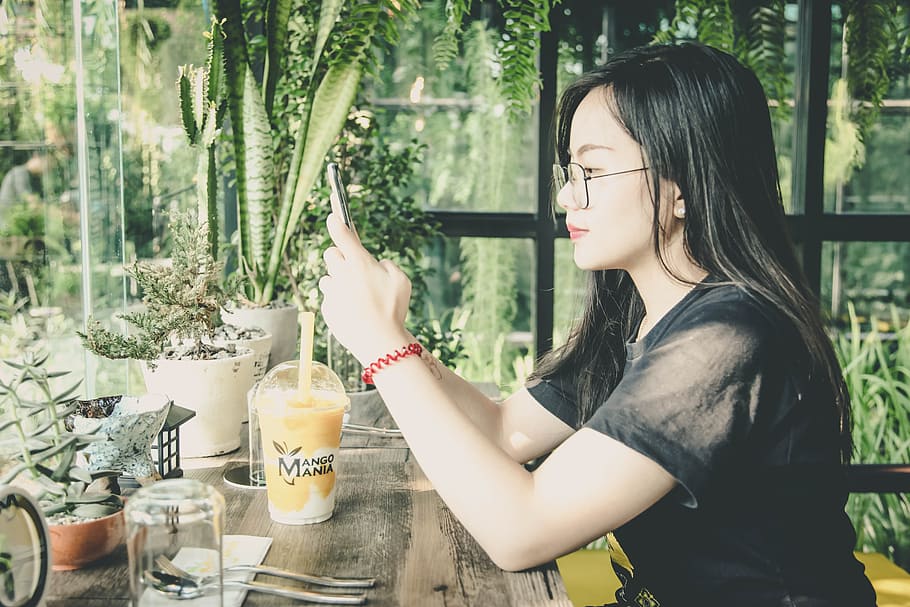 Photo of Woman Using Her Mobile Phone, adult, alone, beverage