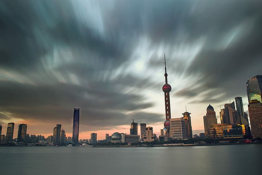 high rise buildings under cloudy sky, timelapse photo of Oriental Pearl Tower, China