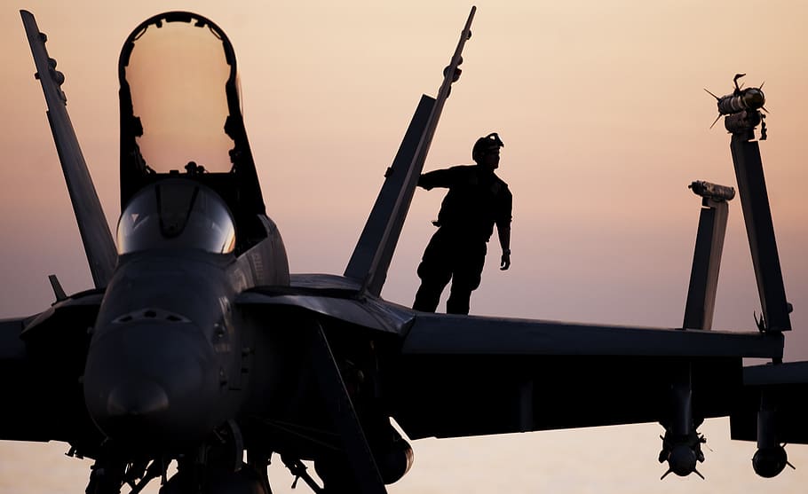 silhouette photography of man on fighter plane, military aircraft