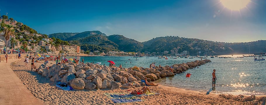people playing on seashore during daytime photo, port de soller