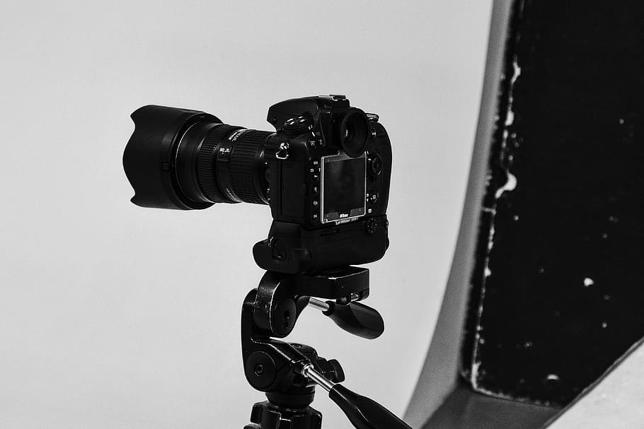 black DSLR camer on white surface, camera, equipment, photography