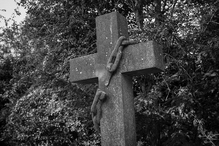 grayscale photography of cross with chain, graves, graveyard