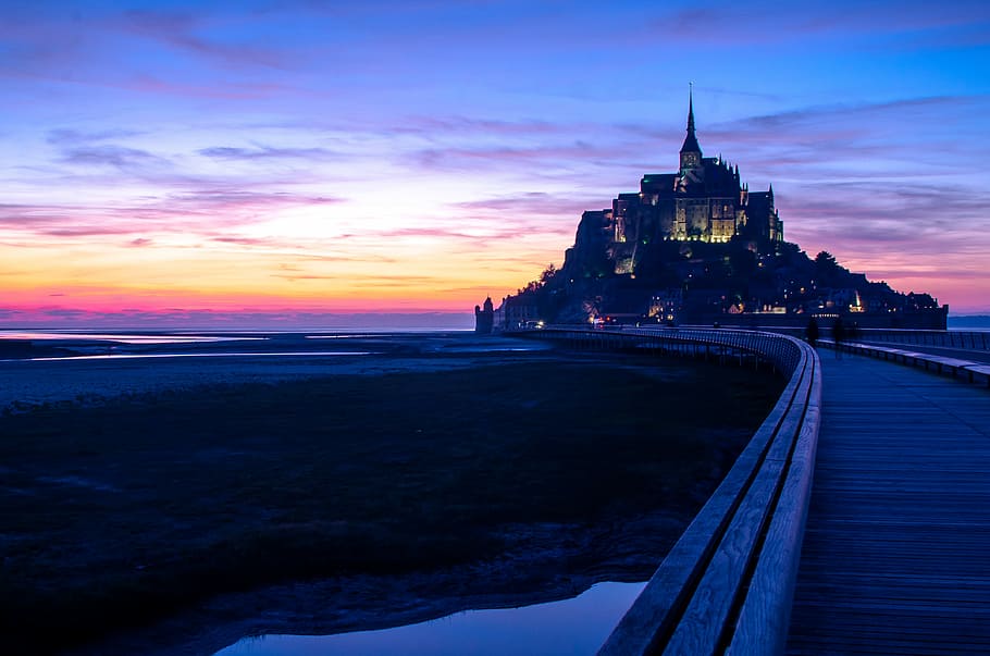 concerete castle during night time, black and brown castle beside road HD wallpaper