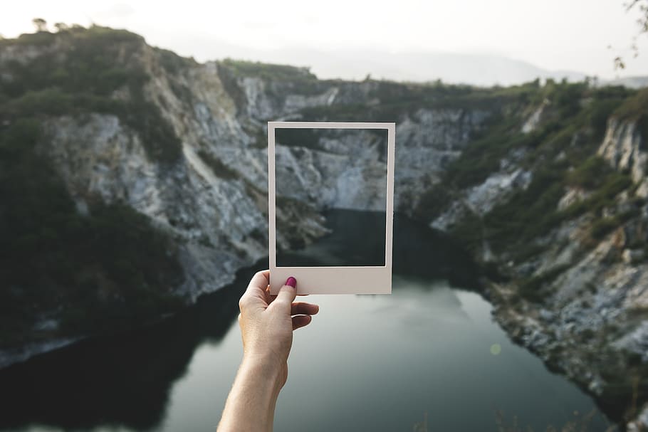 person holding white frame mirror facing mountain during daytime, HD wallpaper