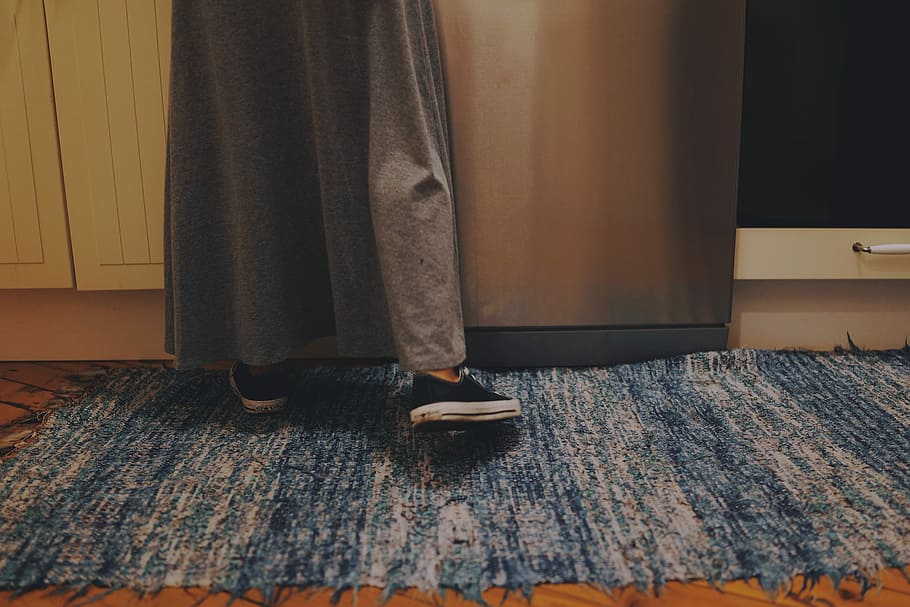 person standing at kitchen, person standing beside stainless steel dishwasher HD wallpaper