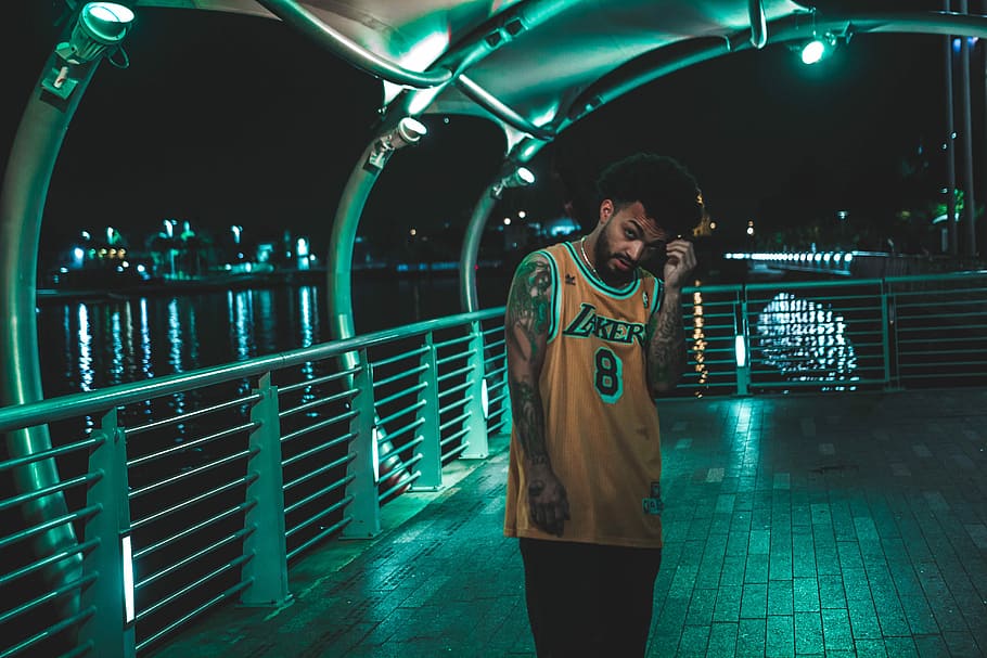 man standing on gray concrete floor near stainless steel handrail, man wearing yellow Los Angeles Lakers 8 Kobe Bryant jersety, HD wallpaper