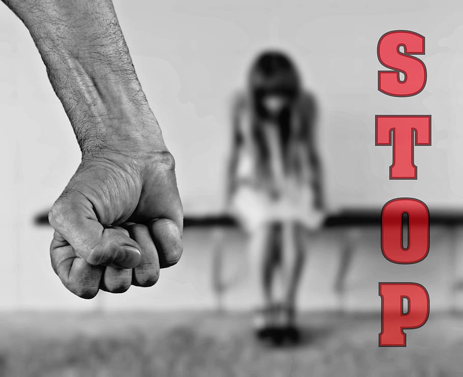 selective color photo of stop with fist violence, fear, violence against women