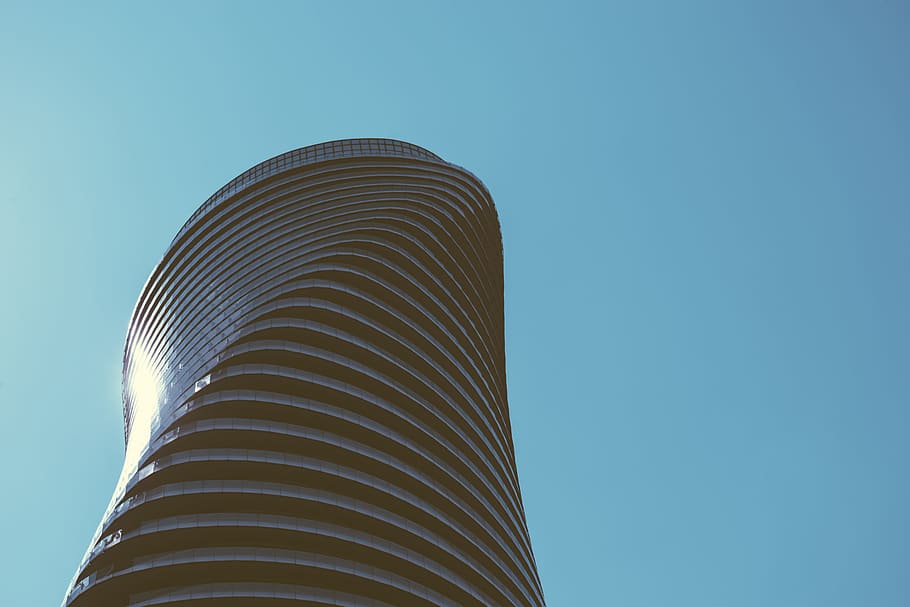 low angle photography of black high-rise building, low angle photography of spiral building during daytime HD wallpaper