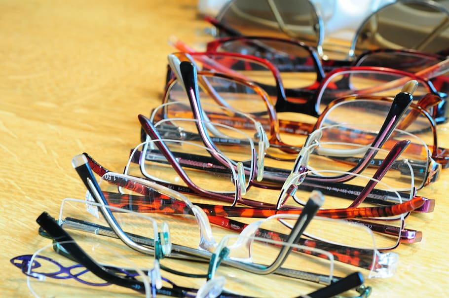 assorted-color eyeglasses on brown surface, sehhilfe, glasses and opticians